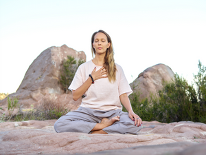 Woman breathing in outdoor space.