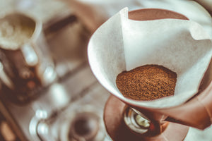 Fresh coffee grounds in a coffee filter.