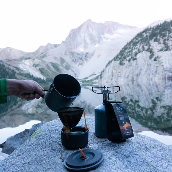 Brewing Peak State's organic Immunity Boost coffee on a hike.