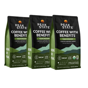 Three bags of Peak State Coffee with Benefits Calm Descent coffee in dark green and black packaging, arranged side-by-side on a white background.