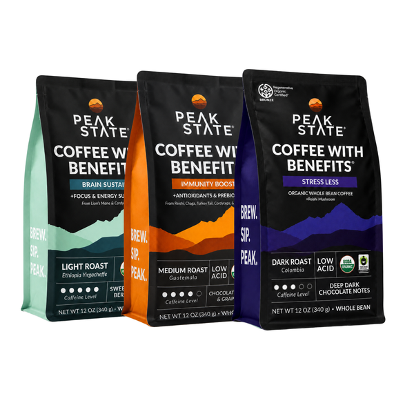 Three bags of Peak State Coffee with Benefits whole bean coffee in different flavors and roasts: Light Roast (Ethiopia Yirgacheffe), Medium Roast (Guatemal), and Dark Roast (Colombia). The bags are black with colorful accents (teal, orange, and purple) and are arranged against a plain white background.