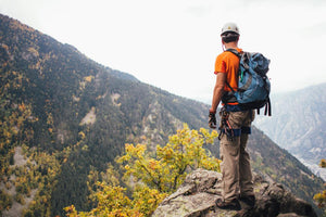 Man on a mountain peak during hike.